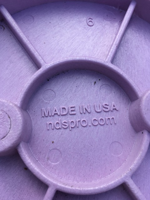 the purple lid of a valve box cover indicates reclaimed water